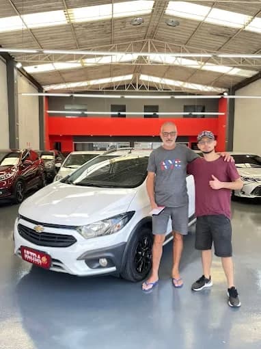 Cliente da Ultra Veículos com o carro que comprou na loja